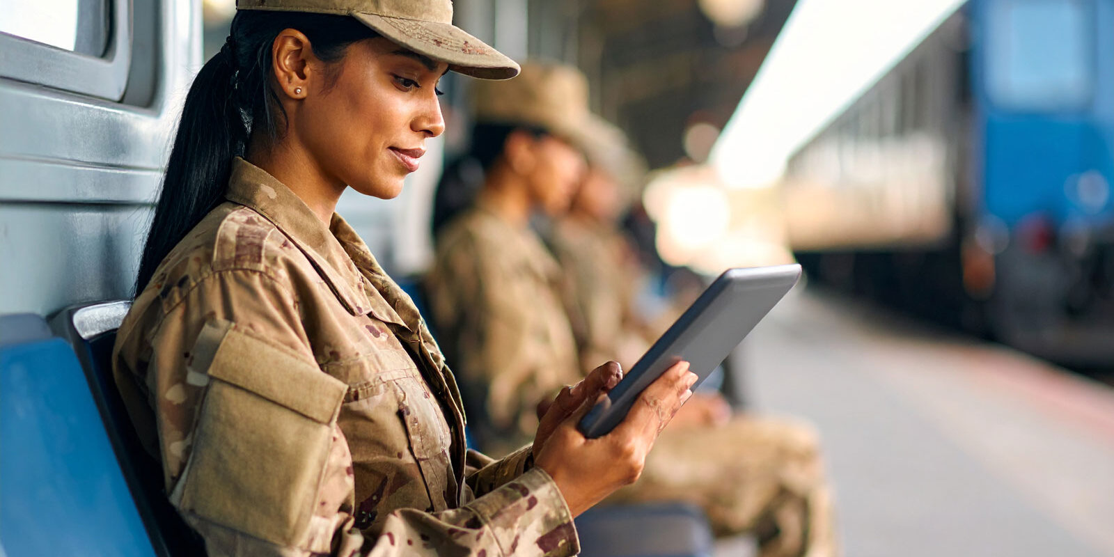 military-woman-reading-a-tablet-sitting-down military-woman-reading-a-tablet-sitting-down